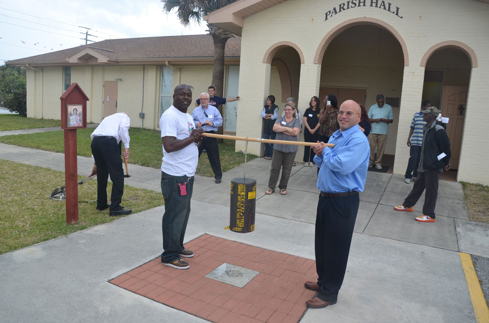 Seth Penalver, left, on death row for almost 19 years before his exoneration in 2013. Herman Lindsay, right, was exonerated a few years before. They're seen here in an appearance in Flagler Beach shoertly after Penalver's release, holding a ceremonial Death Penalty Bell, tolled every time an inmate is executed at the state prison in Starke. (© FlaglerLive)